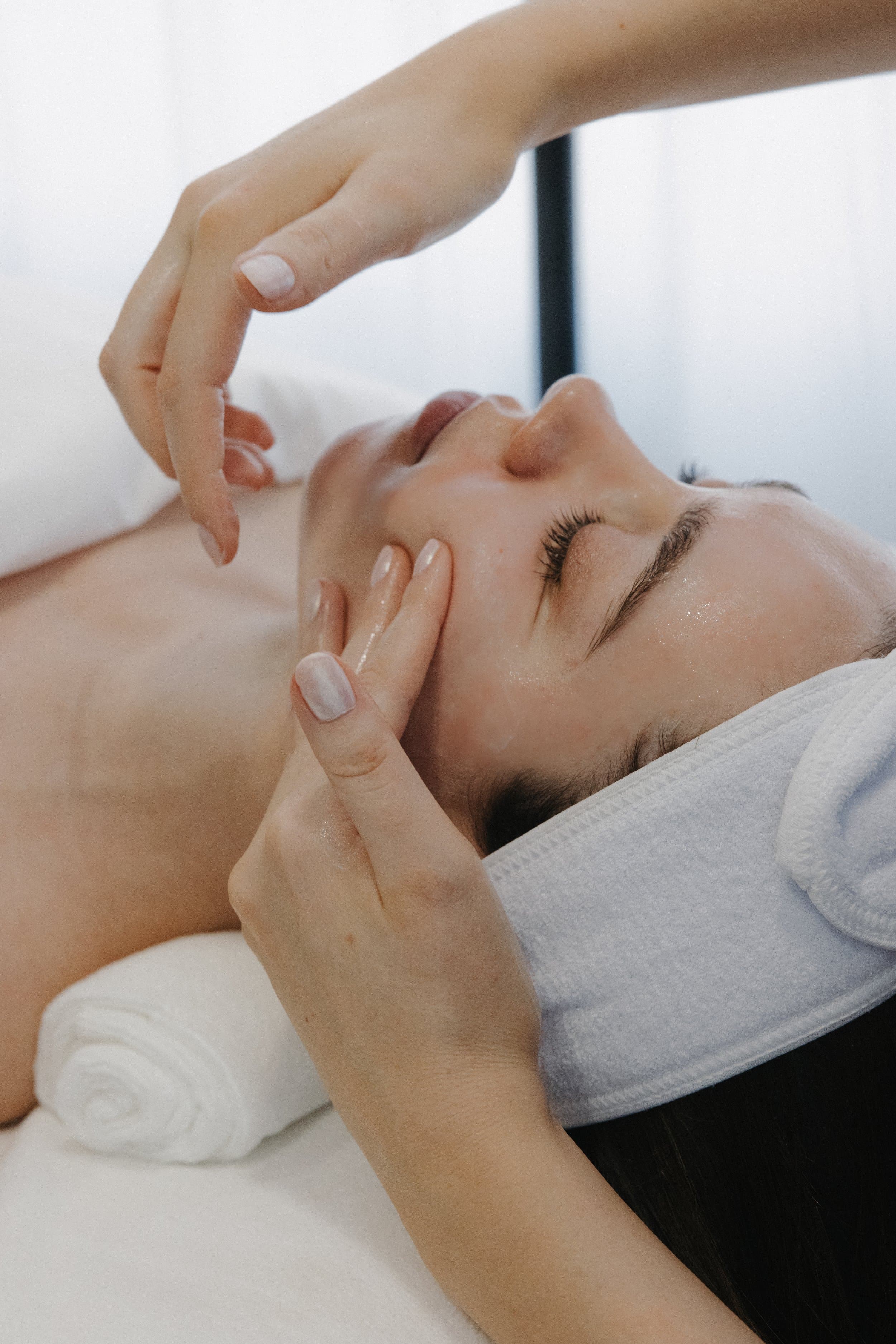 Hannah performing a facial treatment